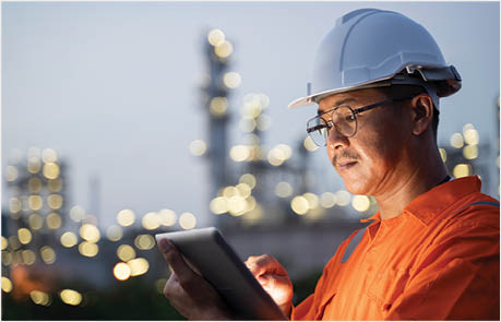 Engineer checks shipment of chemicals at oil and gas industry pipeline job site.